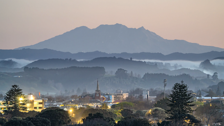 Dawn view over Whanganui city with Mount Ruapehu in the distance and mist rolling through the hills — the landscape that inspires Papaiti Gin’s locally crafted spirits. Photo by Adrian Rumney.